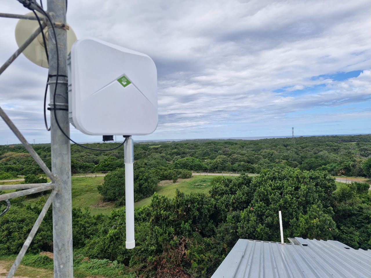 LoRaWAN gateway installed on farm infrastructure overlooking agricultural landscape